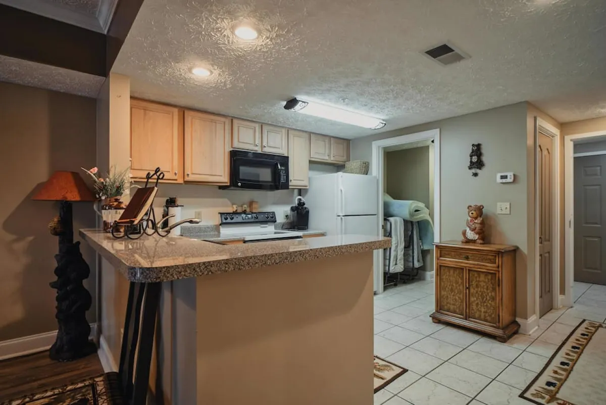 The image features a kitchen countertop with kitchen appliances and decorative items, providing a closer look at the cooking area. The setup suggests a space designed for both practical use and socializing, making it ideal for preparing and sharing meals.
